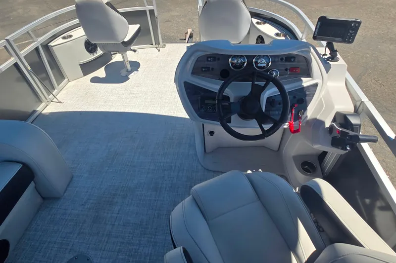 Slide: The Image of Interior view of 2025 BERSHIRE SE 16 boat, featuring steering console and seating. - 8
