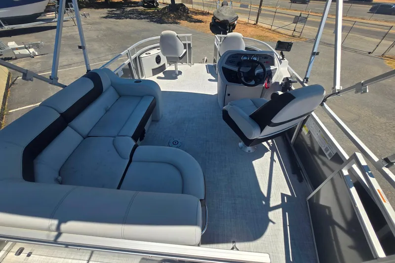 Slide: The Image of 2025 BERSHIRE SE 16 pontoon boat interior with seating and steering console. - 6