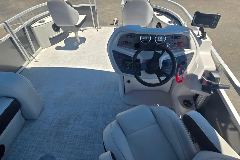 Slide: The Image of Interior view of 2025 BERSHIRE SE 16 boat, featuring modern steering console and seating. - 10
