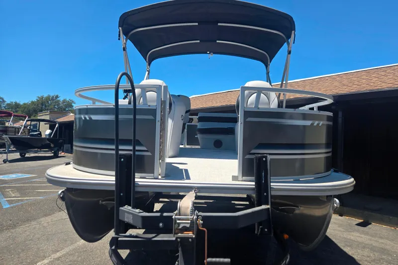Slide: The Image of 2025 BERSHIRE SE 16 pontoon boat with canopy, parked outdoors on a sunny day. - 5