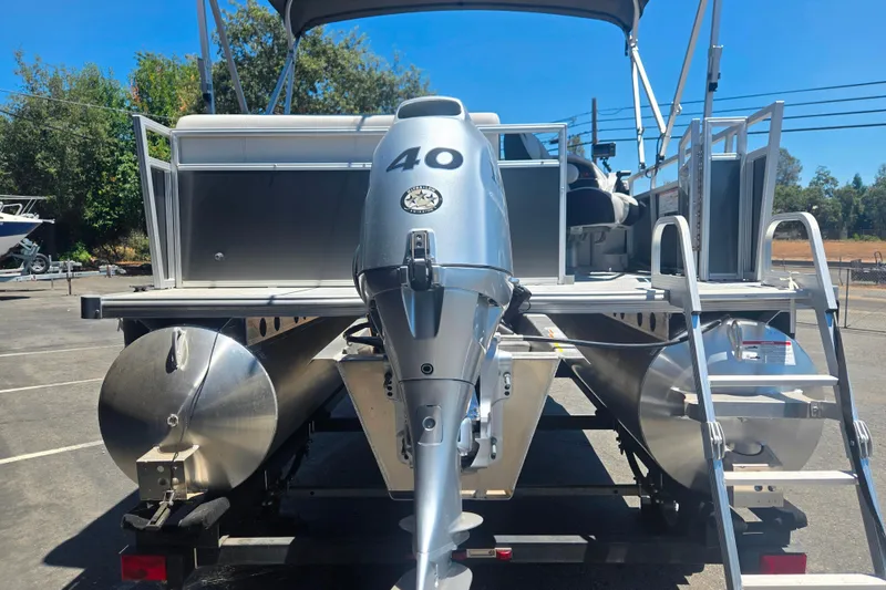 Slide: The Image of 2025 BERSHIRE SE 16 pontoon boat with 40 HP motor, parked outdoors. - 3