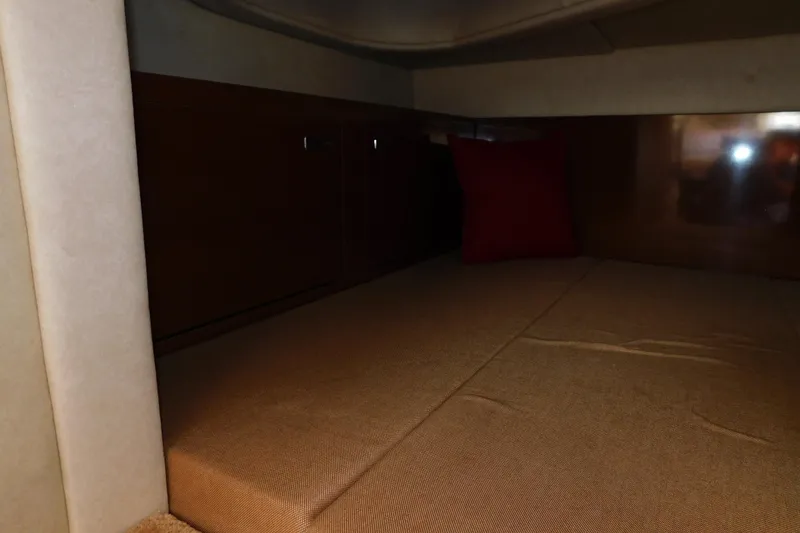 Slide: The Image of Interior cabin of 2010 Sea Ray Sundancer 260 with cushioned seating and wooden paneling. - 44
