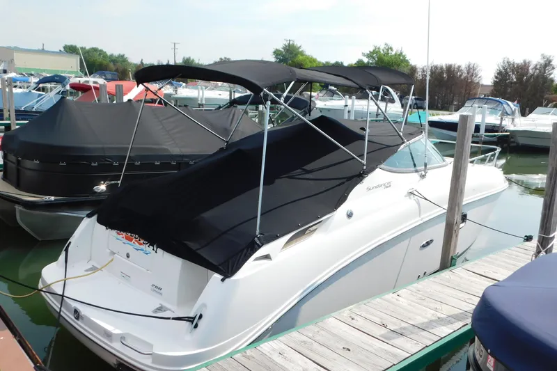 Slide: The Image of 2010 Sea Ray Sundancer 260 docked at marina with black canopy cover. - 1