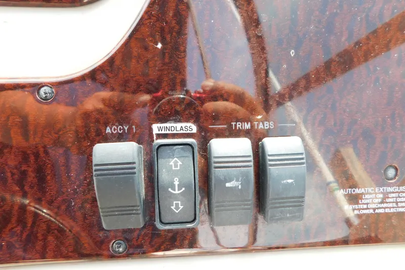 Slide: The Image of Control panel of a 2010 Sea Ray Sundancer 260 boat with switches for accessories. - 36