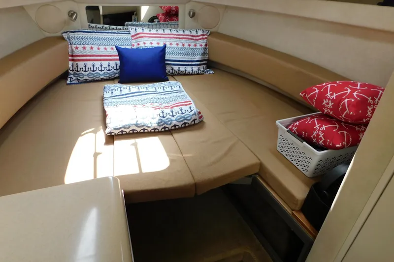 Slide: The Image of Cozy cabin interior of 2010 Sea Ray Sundancer 260 with nautical-themed pillows. - 49