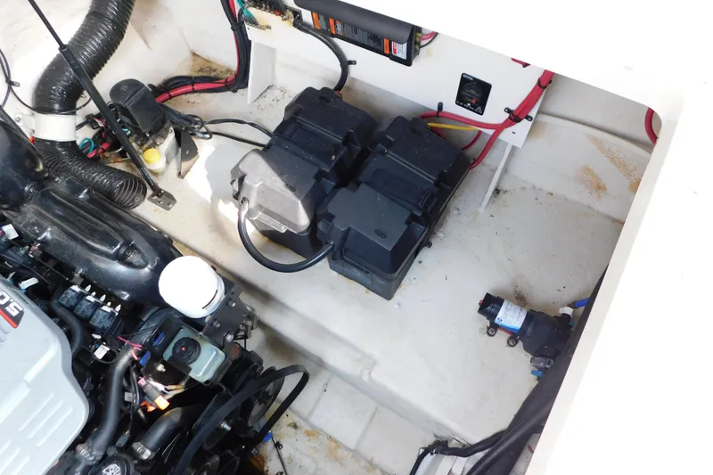 Slide: The Image of Engine compartment of a 2010 Sea Ray Sundancer 260, showing batteries and wiring. - 11