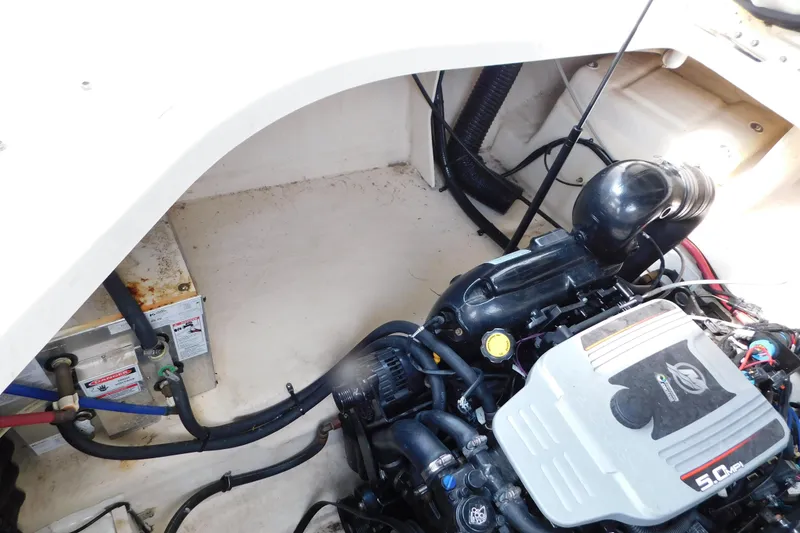 Slide: The Image of Engine compartment of a 2010 Sea Ray Sundancer 260 boat, showcasing the 5.0 MPI engine. - 12