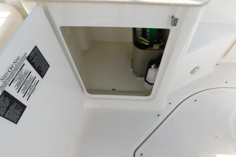 Slide: The Image of Open storage compartment on 2010 Sea Ray Sundancer 260 boat interior. - 18