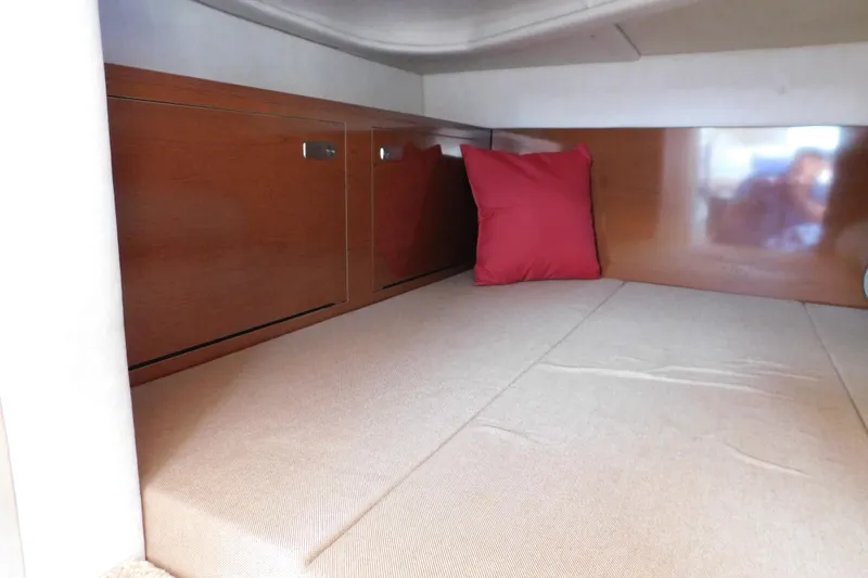 Slide: The Image of Interior cabin of 2010 Sea Ray Sundancer 260 with wood paneling and red cushion. - 45
