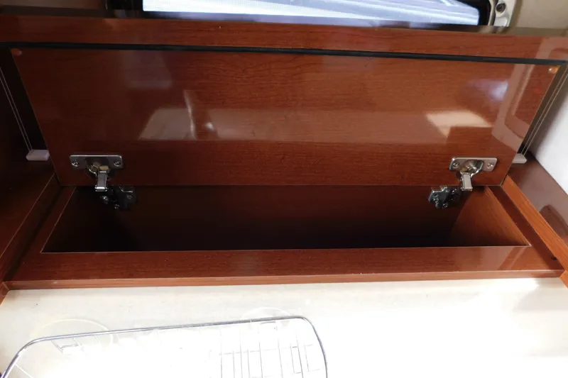 Slide: The Image of Open wooden storage compartment on 2010 Sea Ray Sundancer 260 boat interior. - 61