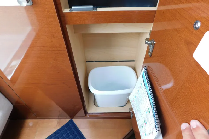 Slide: The Image of Cabinet interior with trash bin on 2010 Sea Ray Sundancer 260 boat. - 68