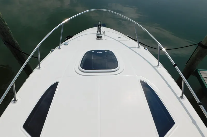 Slide: The Image of Bow view of 2010 Sea Ray Sundancer 260, featuring sleek design and stainless steel railings. - 38