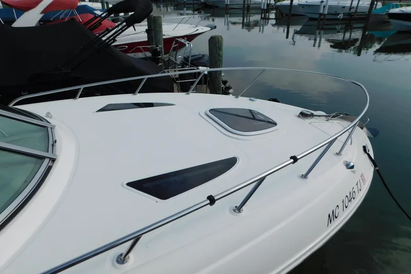 Slide: The Image of 2010 Sea Ray Sundancer 260 docked, showcasing sleek design and modern features. - 5