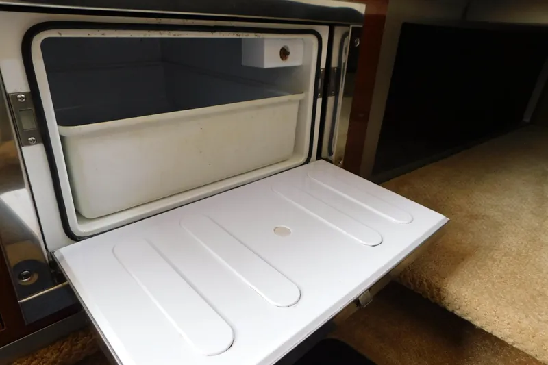Slide: The Image of Open refrigerator compartment in 2010 Sea Ray Sundancer 260 boat interior. - 54