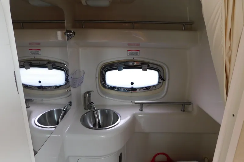Slide: The Image of Interior of 2010 Sea Ray Sundancer 260 bathroom with sink and porthole window. - 71