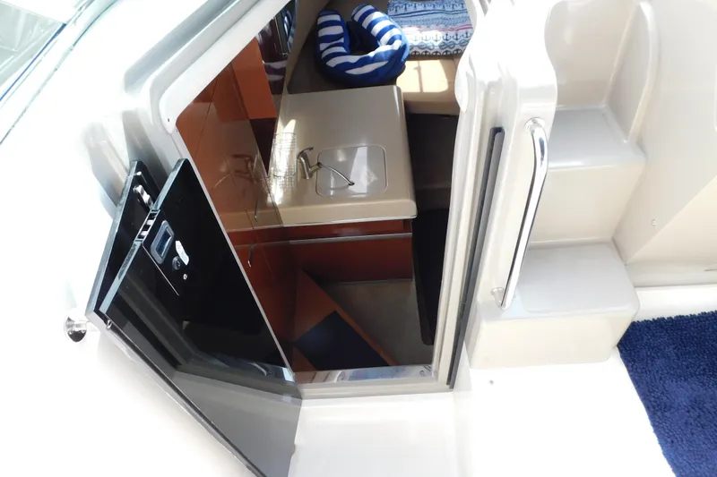 Slide: The Image of Interior view of 2010 Sea Ray Sundancer 260 cabin with open door and seating area. - 42