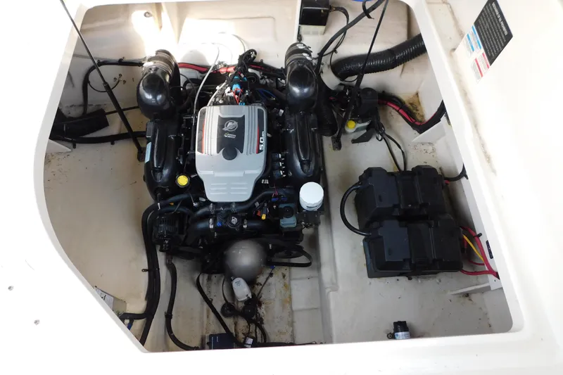 Slide: The Image of Engine compartment of a 2010 Sea Ray Sundancer 260 boat, showcasing the engine and battery setup. - 10