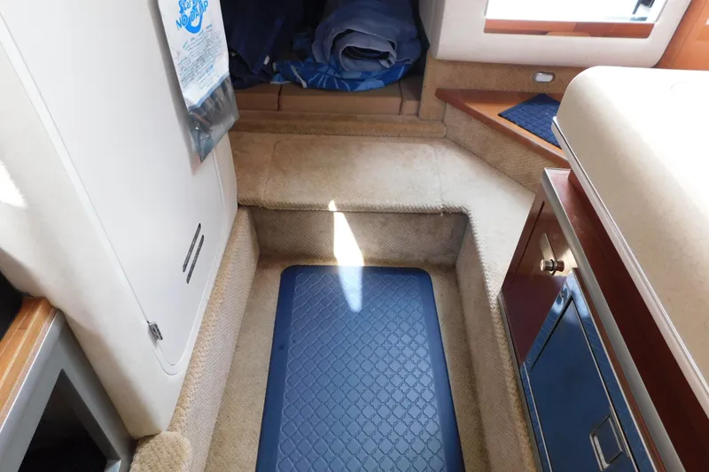 Slide: The Image of Interior of 2010 Sea Ray Sundancer 260 boat, featuring carpeted steps and storage area. - 56