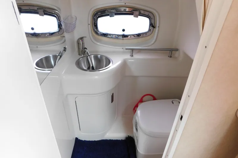 Slide: The Image of Compact bathroom in a 2010 Sea Ray Sundancer 260 boat with sink and toilet. - 70