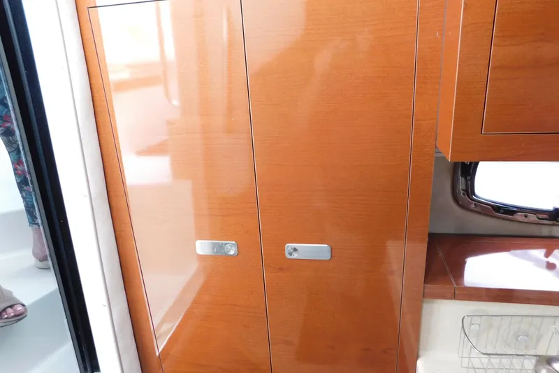 Slide: The Image of Interior of 2010 Sea Ray Sundancer 260 with wooden cabinetry and modern design. - 64