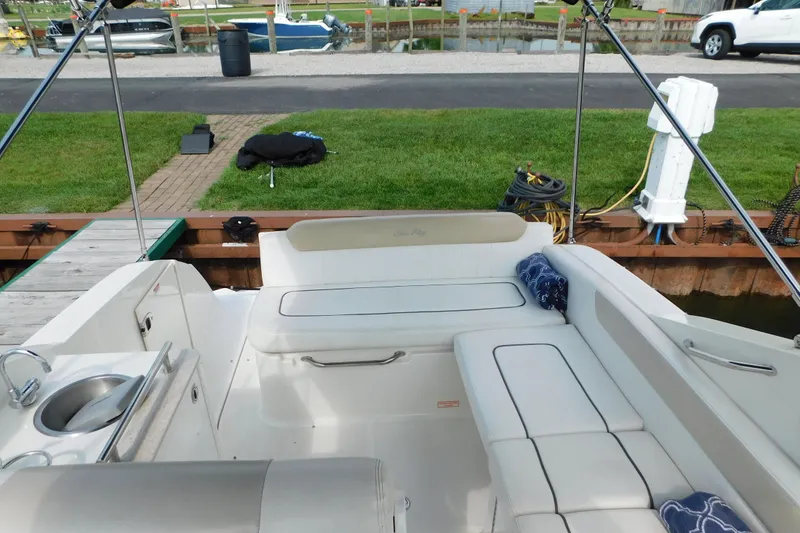 Slide: The Image of 2010 Sea Ray Sundancer 260 boat interior with white seating and small sink. - 30