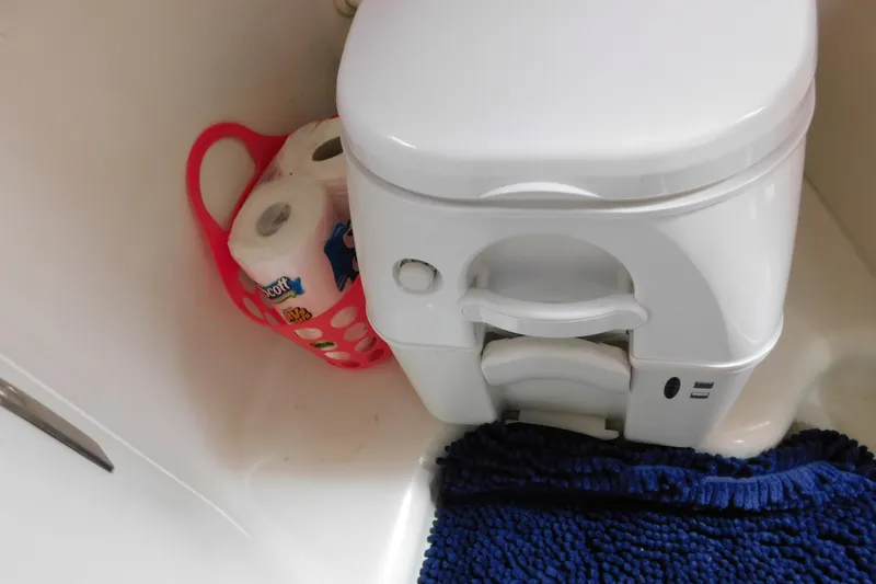 Slide: The Image of Boat bathroom with toilet, toilet paper, and blue mat on Sea Ray Sundancer 260, 2010 model. - 74