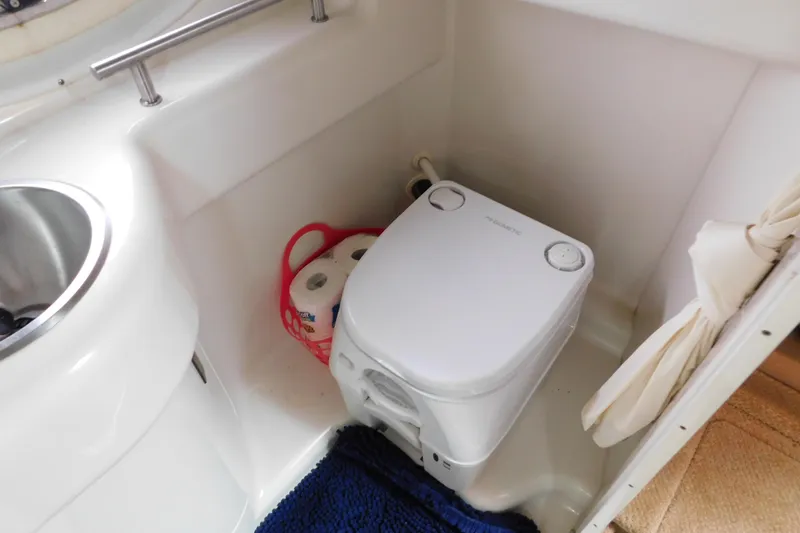 Slide: The Image of Compact bathroom in 2010 Sea Ray Sundancer 260 with portable toilet and sink. - 73