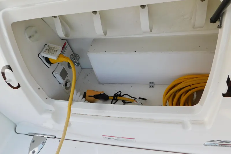 Slide: The Image of Storage compartment of 2010 Sea Ray Sundancer 260 with electrical cables and equipment. - 8