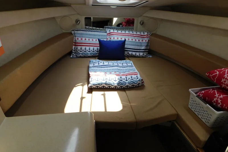 Slide: The Image of Cozy cabin interior of 2010 Sea Ray Sundancer 260 with nautical-themed bedding. - 50