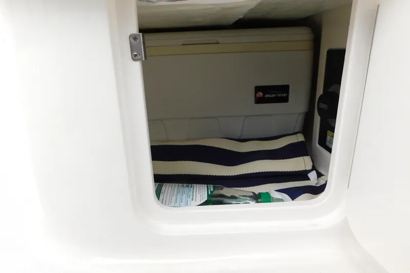 Slide: The Image of Storage compartment in a 2010 Sea Ray Sundancer 260 boat with marine cooler. - 76