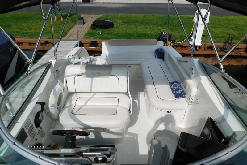 Slide: The Image of 2010 Sea Ray Sundancer 260 boat interior with white seating and steering controls. - 41