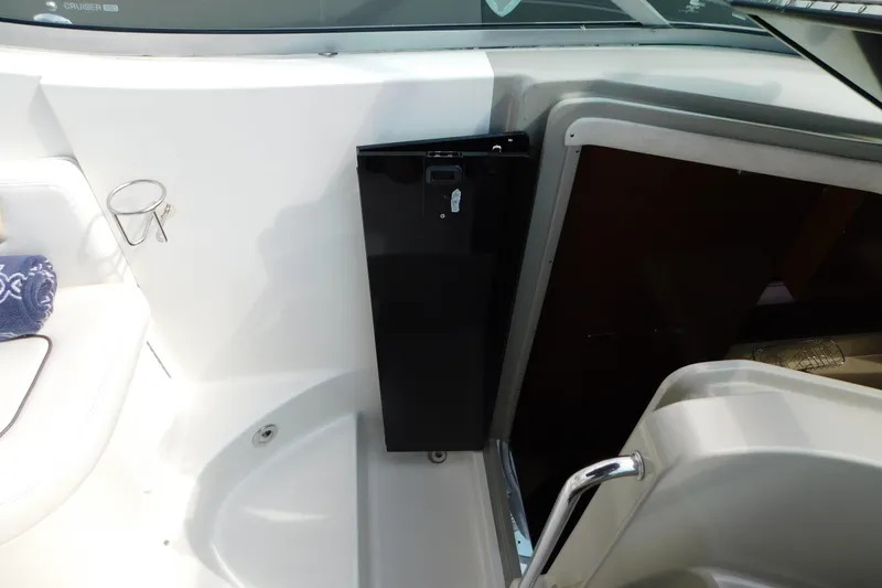 Slide: The Image of 2010 Sea Ray Sundancer 260 interior with seating and storage compartment. - 28