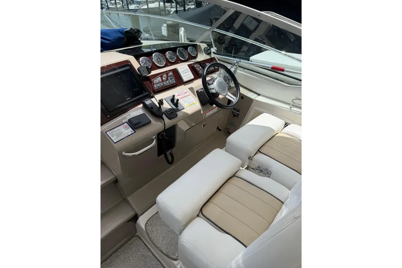 Slide: The Image of 2008 Sea Ray Sundancer 350 helm with steering wheel, gauges, and dual seating. - 37