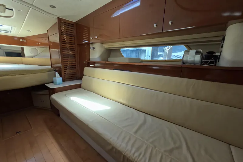 Slide: The Image of Interior of 2008 Sea Ray Sundancer 350 yacht with beige seating and wooden cabinetry. - 27