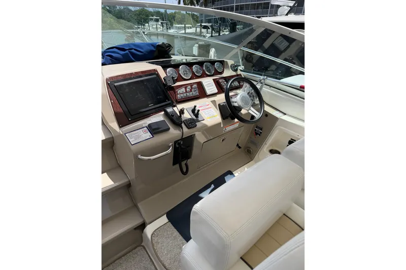 Slide: The Image of Cockpit of 2008 Sea Ray Sundancer 350 with steering wheel and navigation controls. - 36