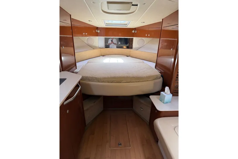 Slide: The Image of Interior cabin of 2008 Sea Ray Sundancer 350 with bed and wooden cabinetry. - 16