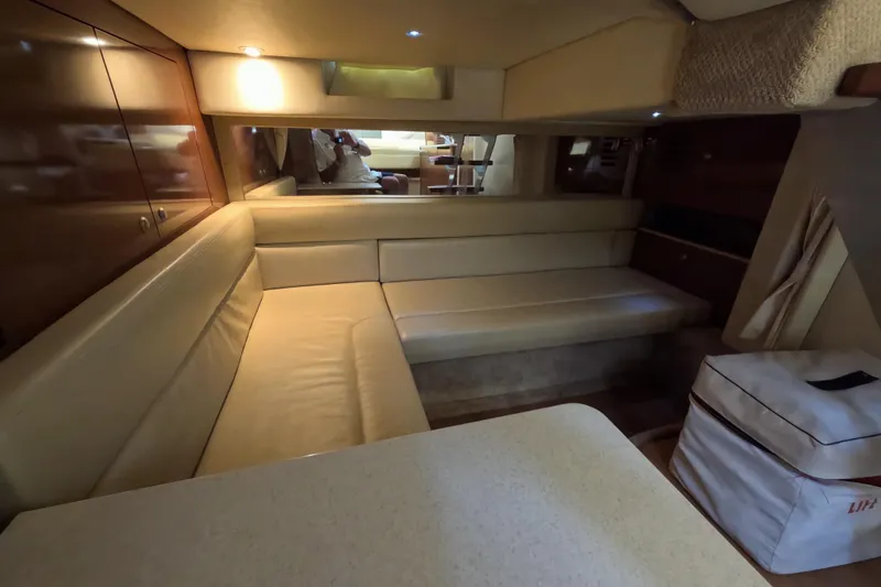Slide: The Image of Interior of 2008 Sea Ray Sundancer 350 yacht with beige seating and wooden cabinetry. - 21