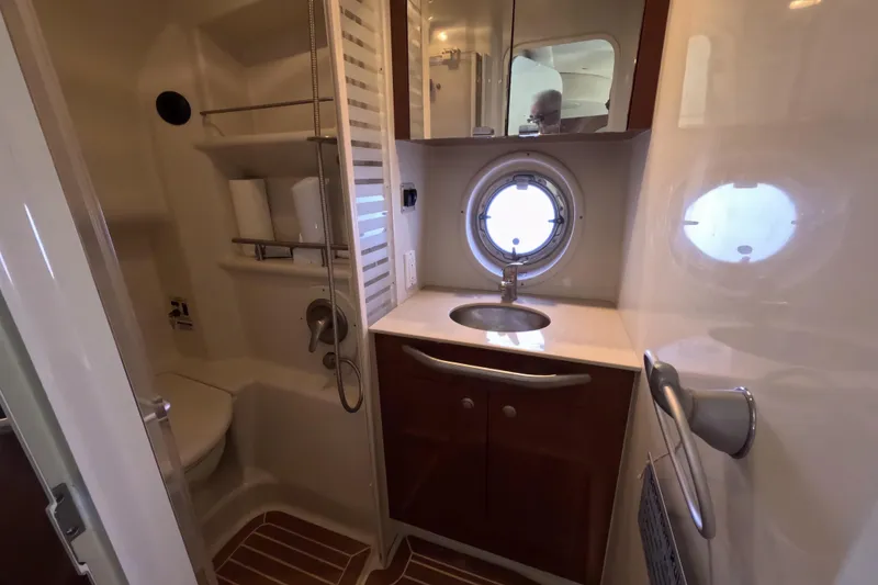 Slide: The Image of Bathroom interior of 2008 Sea Ray Sundancer 350 yacht with sink, shower, and porthole window. - 26