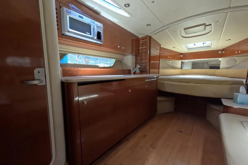 Slide: The Image of Luxurious interior of 2008 Sea Ray Sundancer 350 yacht with wood cabinetry and cozy sleeping area. - 28