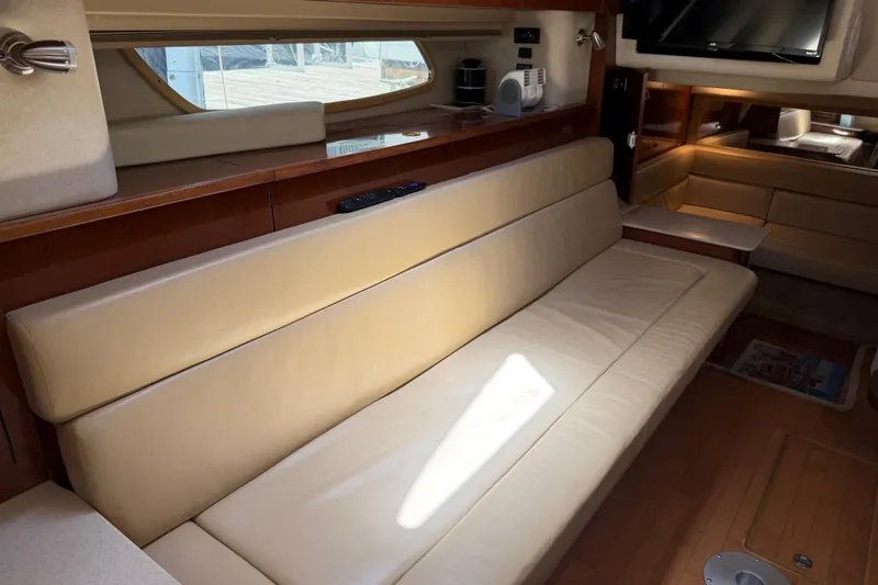 Slide: The Image of Interior of 2008 Sea Ray Sundancer 350 yacht with beige leather seating and wooden accents. - 7