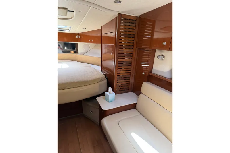 Slide: The Image of Interior of 2008 Sea Ray Sundancer 350 yacht with cozy seating and wooden cabinetry. - 13