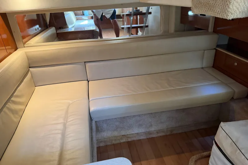 Slide: The Image of Interior of 2008 Sea Ray Sundancer 350 with beige leather seating and wooden flooring. - 18