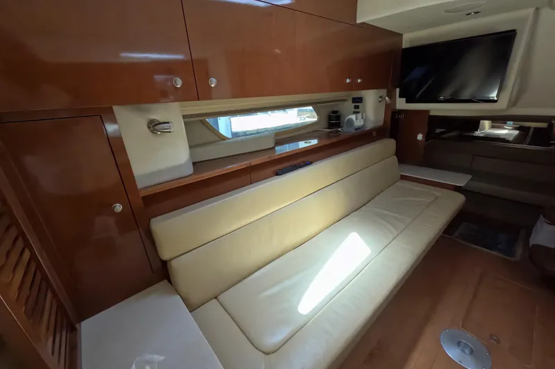Slide: The Image of Interior of 2008 Sea Ray Sundancer 350 with beige seating and wooden cabinetry. - 20