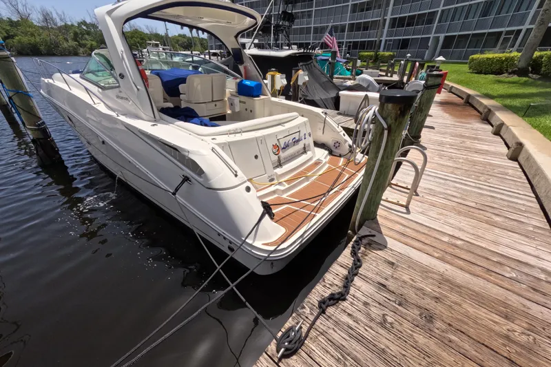 The Image of 2008 Sea Ray Sundancer 350 docked at a marina, showcasing sleek design and spacious deck. - 0