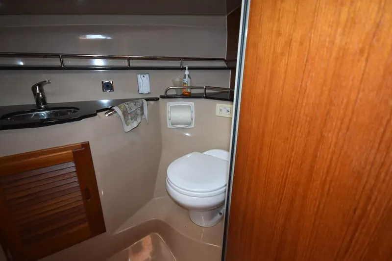 Slide: The Image of Bathroom interior of 2013 Ranger Tugs R-29 with sink, toilet, and wooden cabinetry. - 30