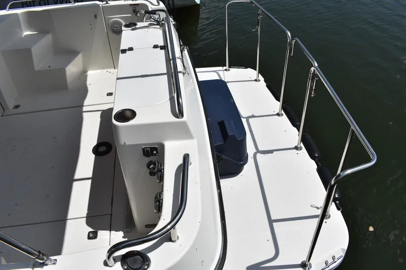 Slide: The Image of 2013 Ranger Tugs R-29 boat deck with railing and water view. - 12