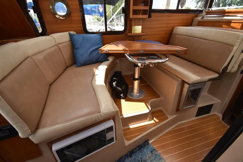 Slide: The Image of Interior of 2013 Ranger Tugs R-29 with beige seating and wooden accents. - 21