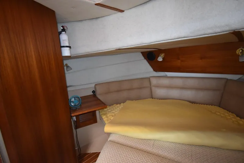 Slide: The Image of Cozy cabin interior of 2013 Ranger Tugs R-29 with bed and wooden accents. - 36