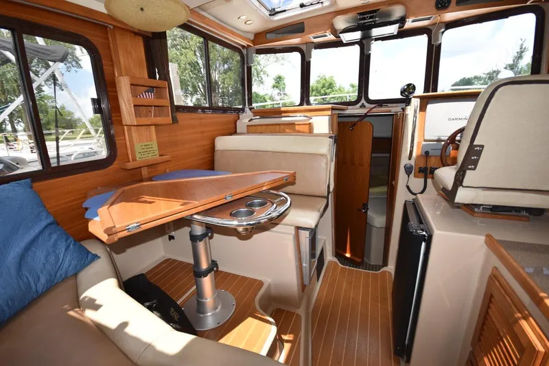 Slide: The Image of Interior of 2013 Ranger Tugs R-29 boat with wood accents and seating area. - 22