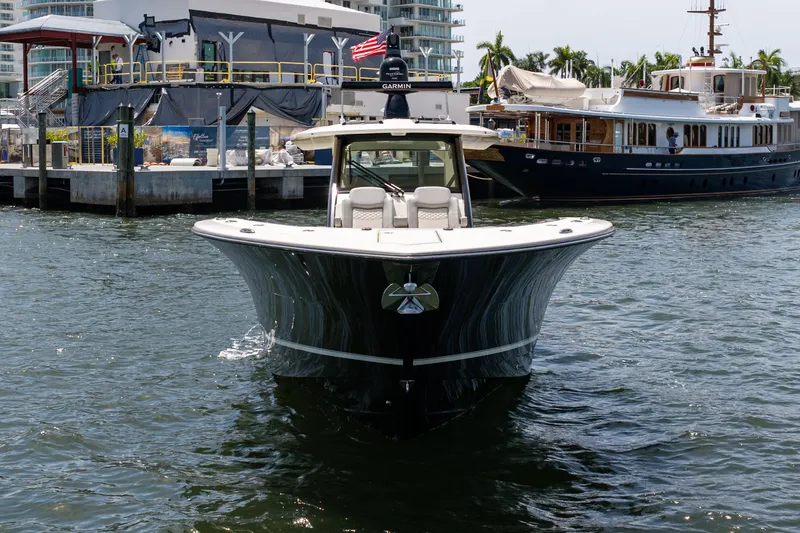 Slide: The Image of 2024 Scout 425 LXF boat docked in marina, featuring sleek design and modern amenities. - 11